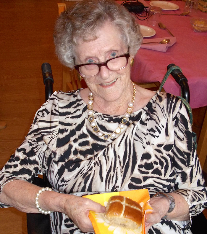 Photo of a lady holding cross bun