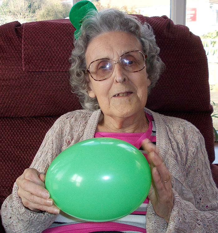 Photo of senior holding a baloon